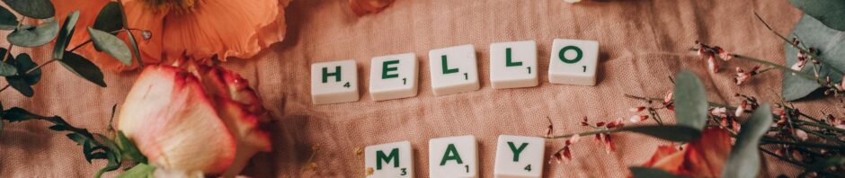 close up shot of scrabble tiles beside flowers
